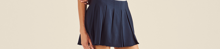 STUDIO SEOUL LOGO BANDING PLEATED SKIRT