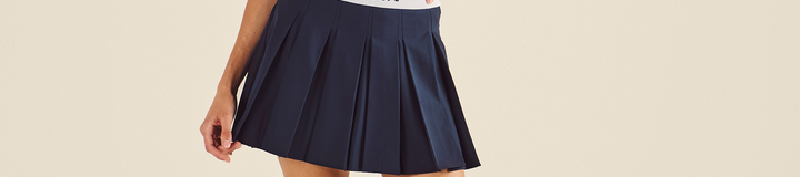STUDIO SEOUL LOGO BANDING PLEATED SKIRT