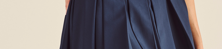 STUDIO SEOUL LOGO BANDING PLEATED SKIRT